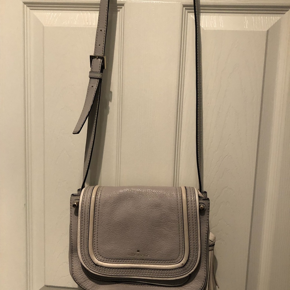 Gray Kate Spade ♠️ with tassel.  Pre-owned with normal wear.  Lots of pockets.